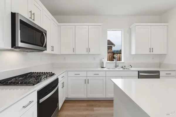 a kitchen with cabinets appliances and a sink