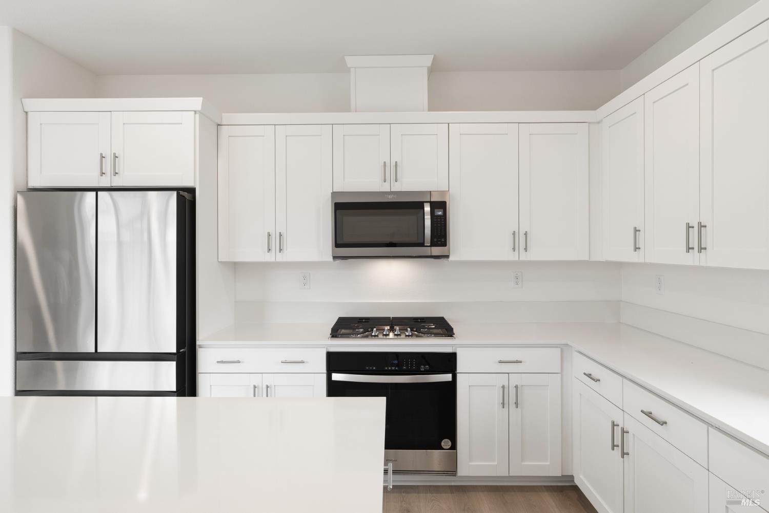 2158 Owens Place Rohnert Park, CA 94928 - Photo 12 of 28 a kitchen with white cabinets and stainless steel appliances