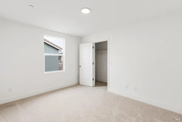 an empty room with a empty space and windows