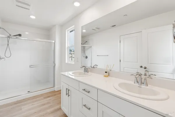 a bathroom with double sink and a mirror