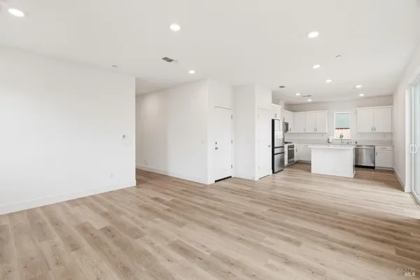 a view of a kitchen with a sink and a refrigerator