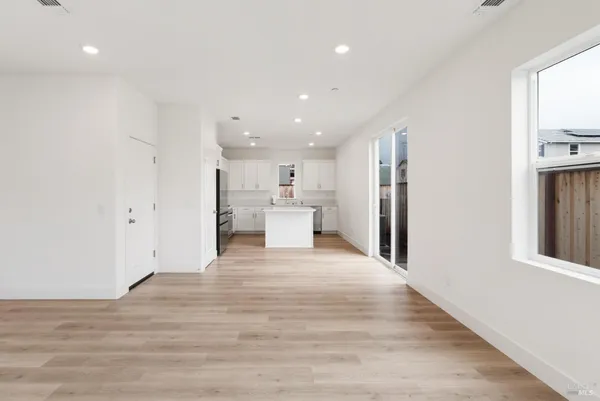 a view of a kitchen with a refrigerator and a window