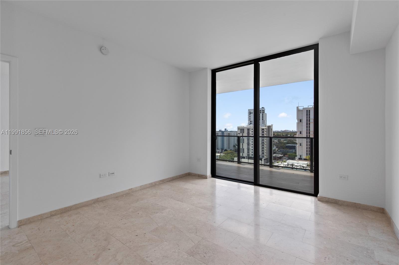 88 Southwest 7th Street, Unit 904 Miami, FL 33130 - Photo 20 of 26 an empty room with sliding glass door and mountain view
