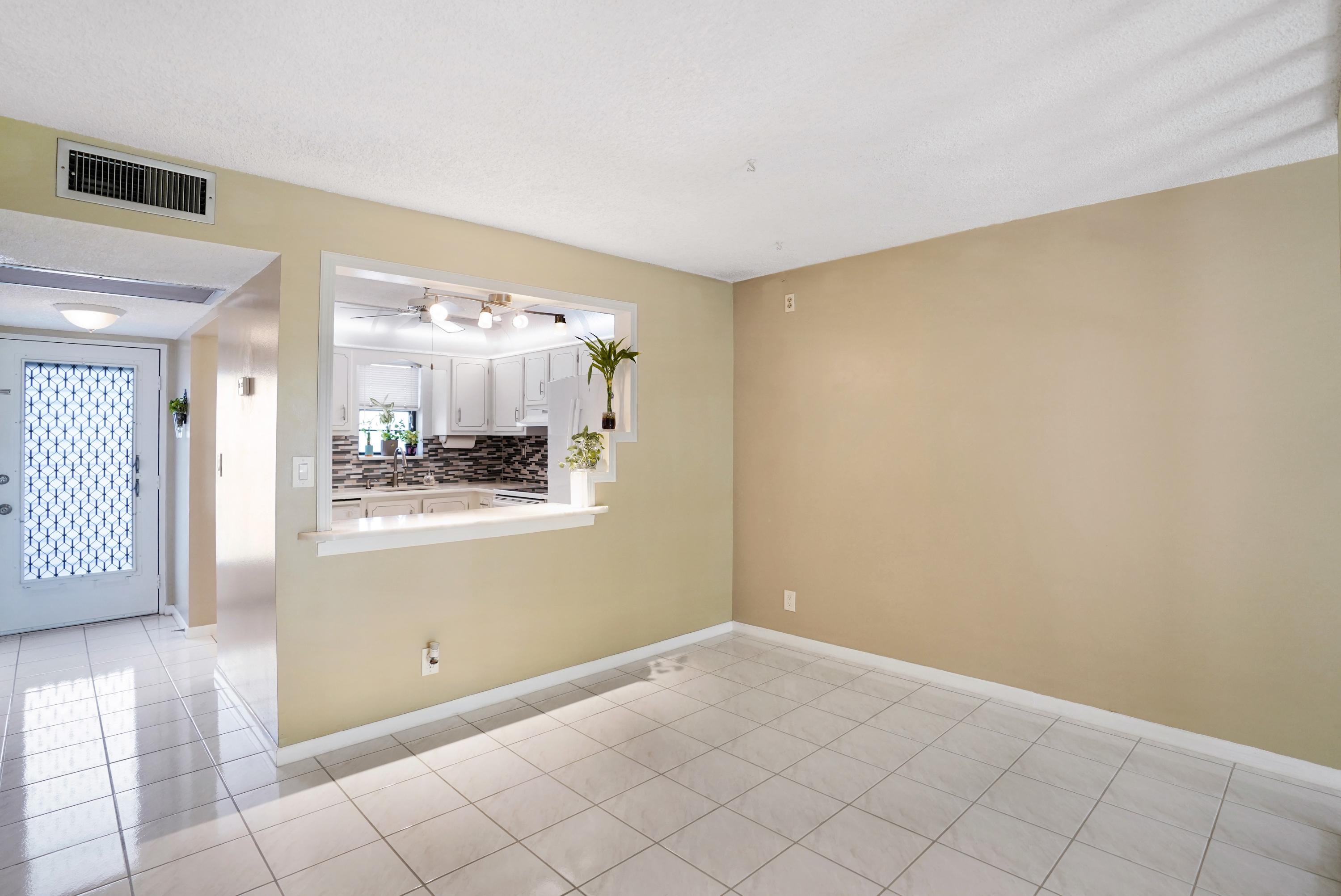 9440 Southwest 8th Street, Unit 206 Boca Raton, FL 33428 - Photo 3 of 28 Kitchen Breakfast Bar onto Dining Area