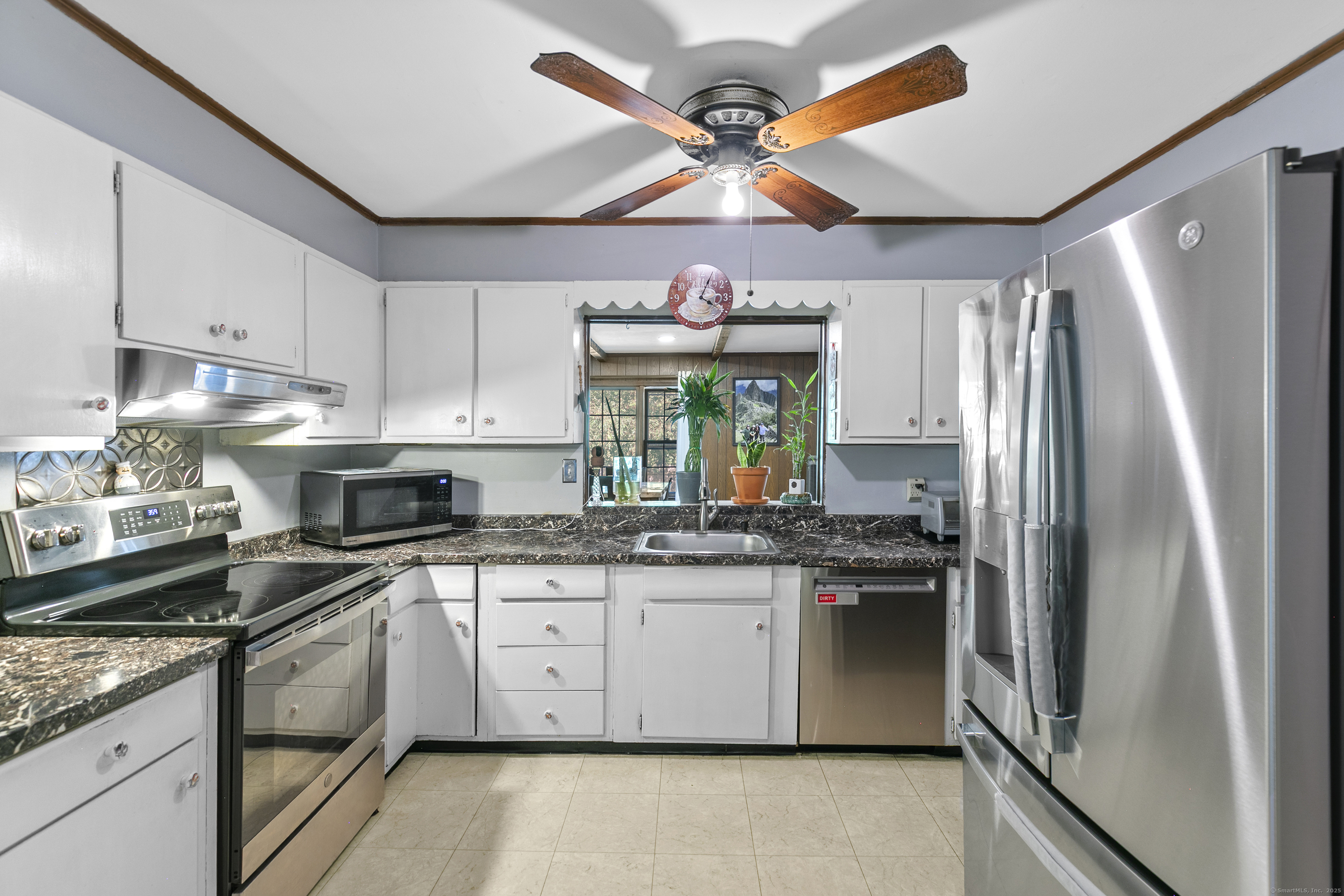 66 Loftus Circle Trumbull, CT 06611 - Photo 11 of 40 a kitchen with stainless steel appliances granite countertop a stove a sink and a refrigerator