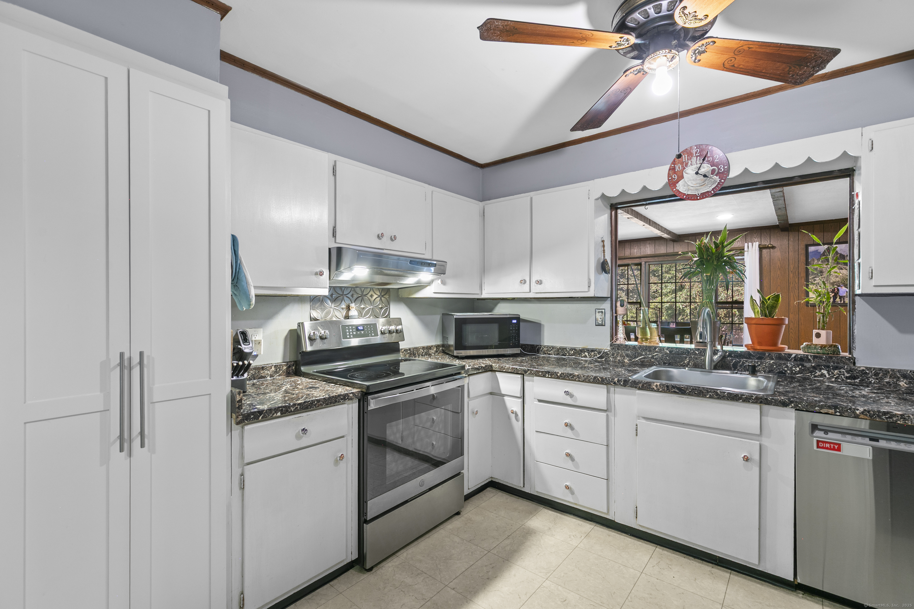 66 Loftus Circle Trumbull, CT 06611 - Photo 12 of 40 a kitchen with white cabinets and white appliances
