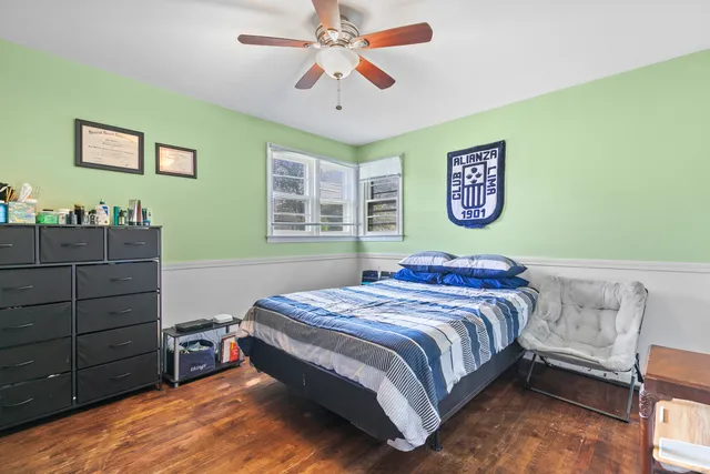 a bedroom with a bed and a dresser