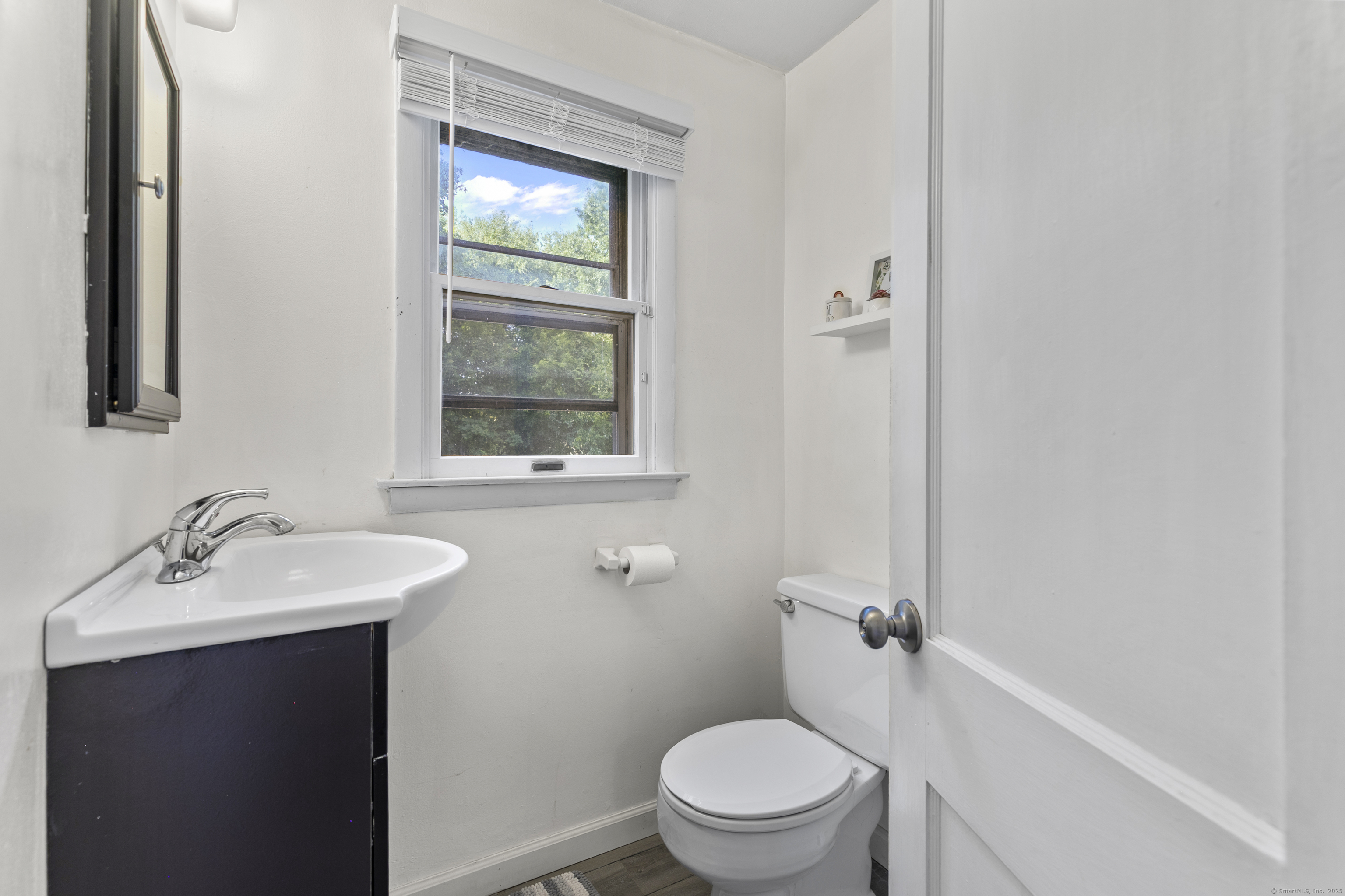 66 Loftus Circle Trumbull, CT 06611 - Photo 26 of 40 a bathroom with a toilet a sink and mirror