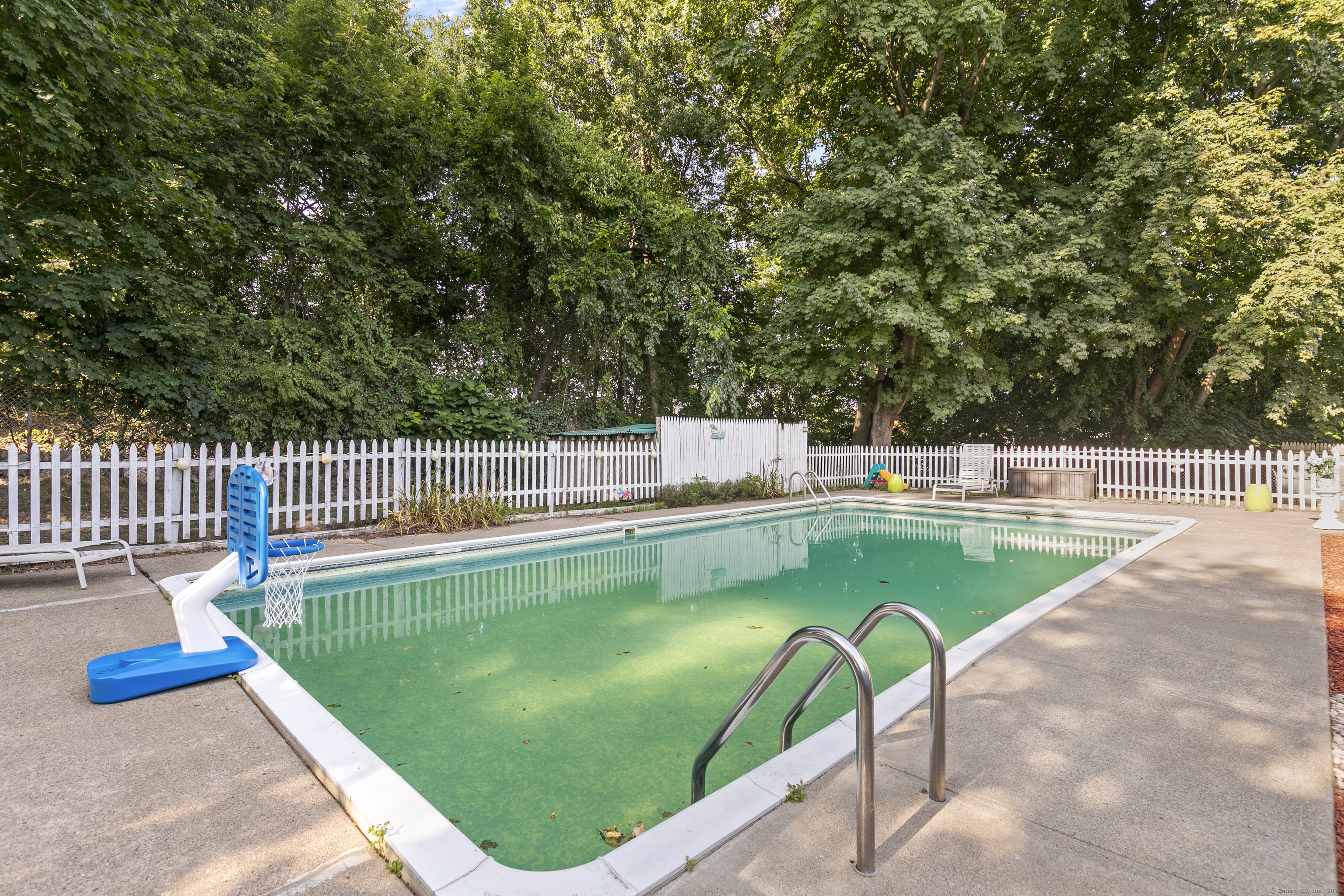 66 Loftus Circle Trumbull, CT 06611 - Photo 39 of 40 a view of a swimming pool with a patio and a garden