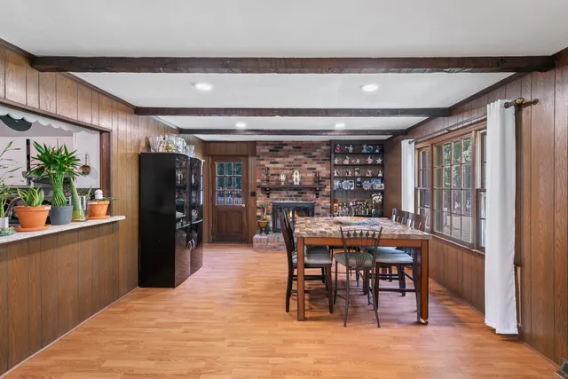 a view of a dining room with furniture and a window