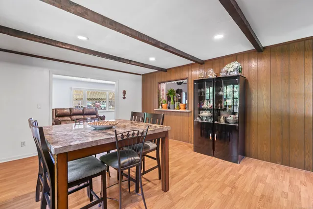 a dining room with furniture and window