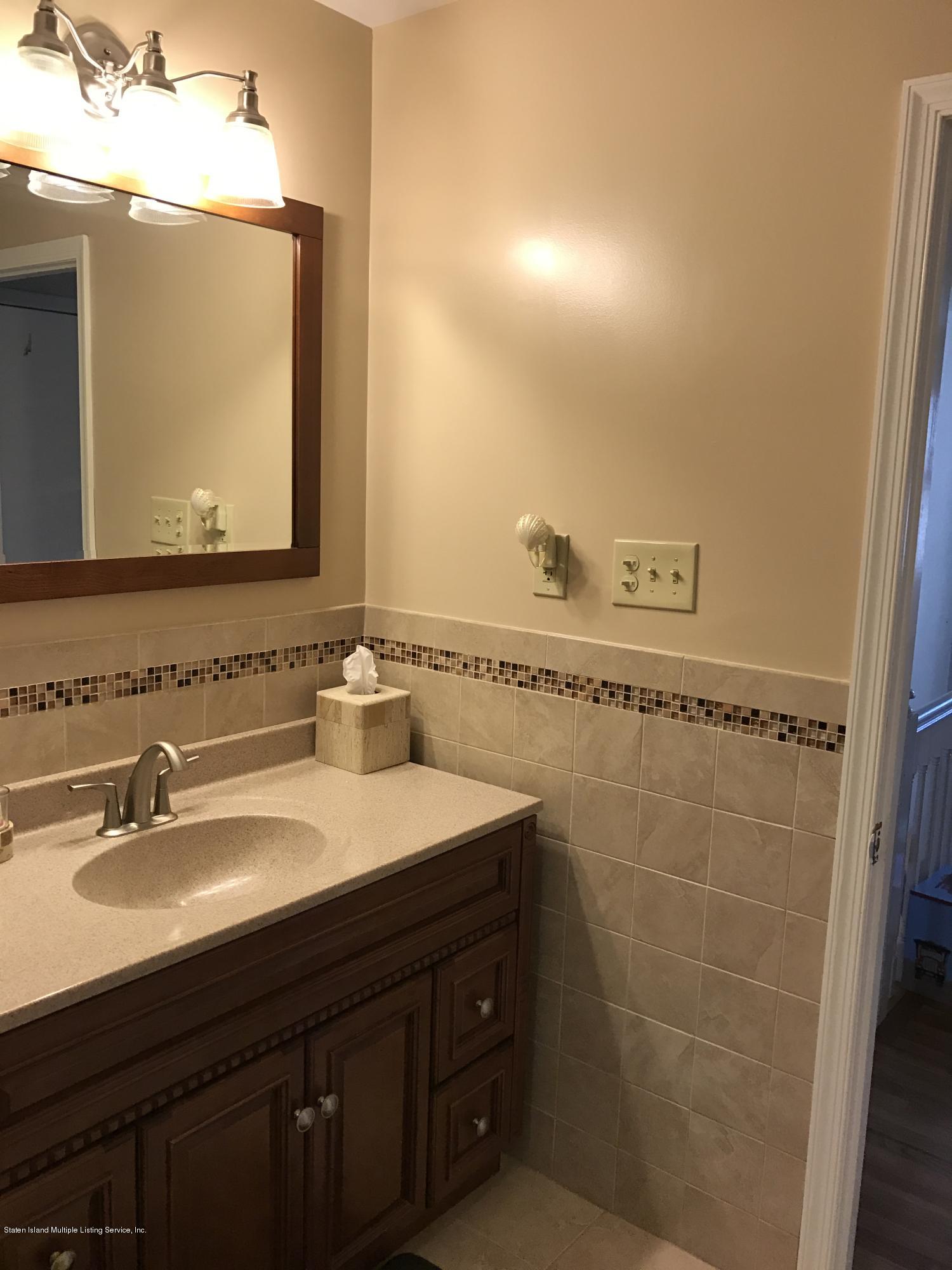 80 Rathbun Avenue Staten Island, NY 10312 - Photo 14 of 21 a bathroom with a sink vanity and a mirror