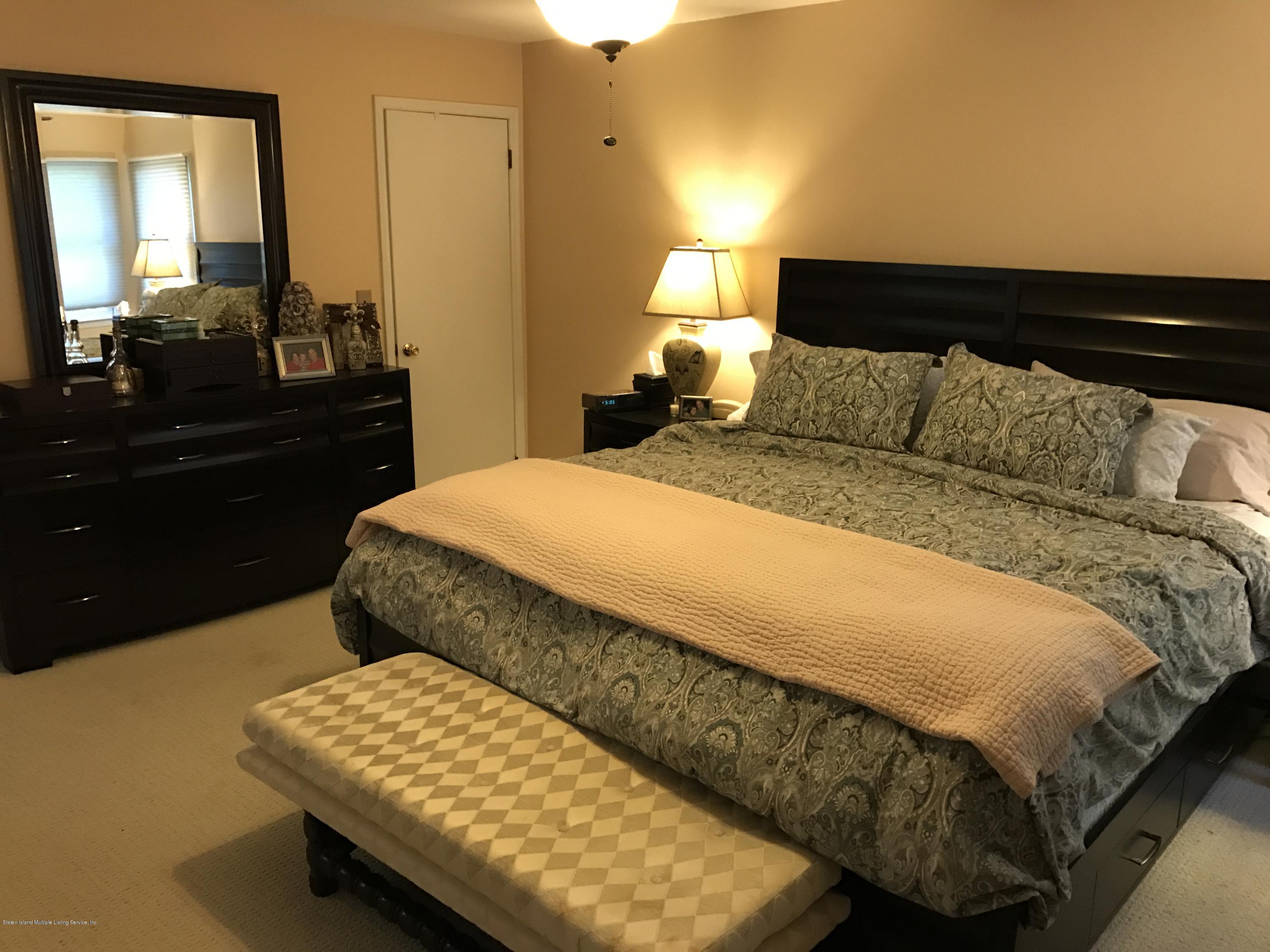 80 Rathbun Avenue Staten Island, NY 10312 - Photo 16 of 21 a bedroom with a bed and dresser with mirror