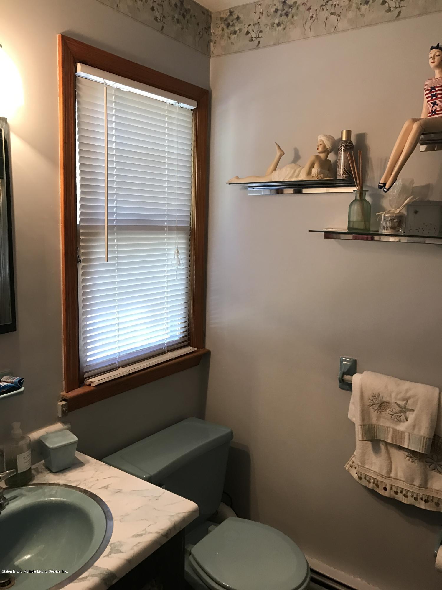80 Rathbun Avenue Staten Island, NY 10312 - Photo 17 of 21 a bathroom with a toilet sink and mirror