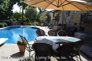 80 Rathbun Avenue Staten Island, NY 10312 - Photo 20 of 21 a view of a patio with table and chairs under an umbrella