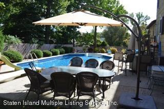 80 Rathbun Avenue Staten Island, NY 10312 - Photo 21 of 21 a view of patio with table and chairs under an umbrella