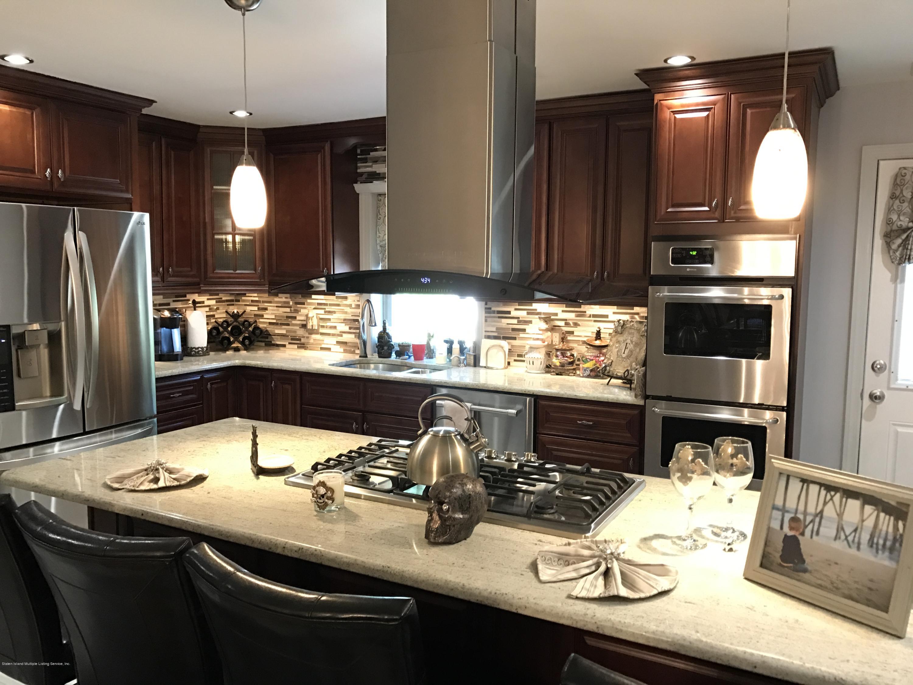 80 Rathbun Avenue Staten Island, NY 10312 - Photo 3 of 21 a kitchen with a sink refrigerator and cabinets