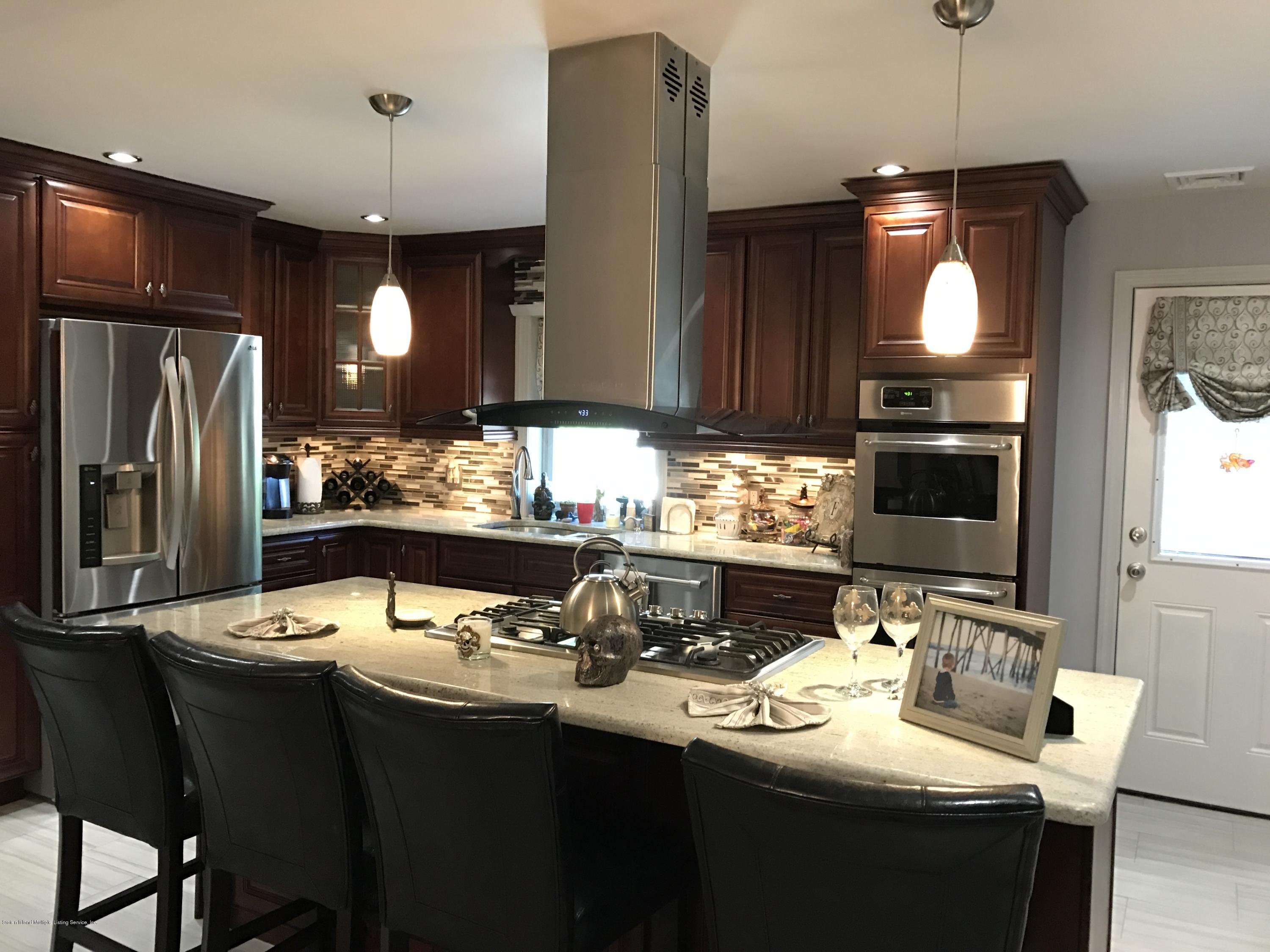 80 Rathbun Avenue Staten Island, NY 10312 - Photo 5 of 21 a kitchen with stainless steel appliances granite countertop a sink and a refrigerator