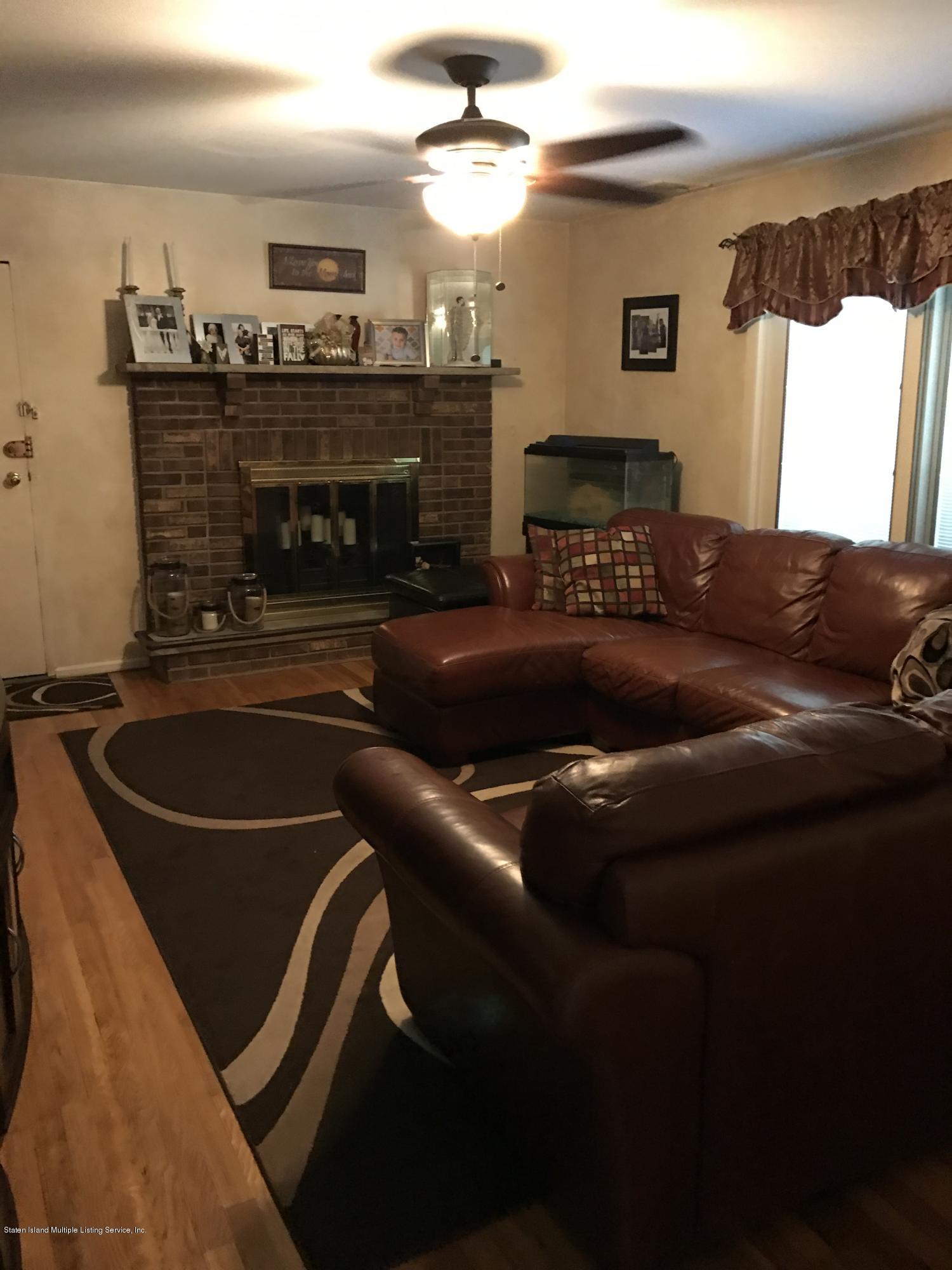 80 Rathbun Avenue Staten Island, NY 10312 - Photo 7 of 21 a living room with furniture and a fireplace