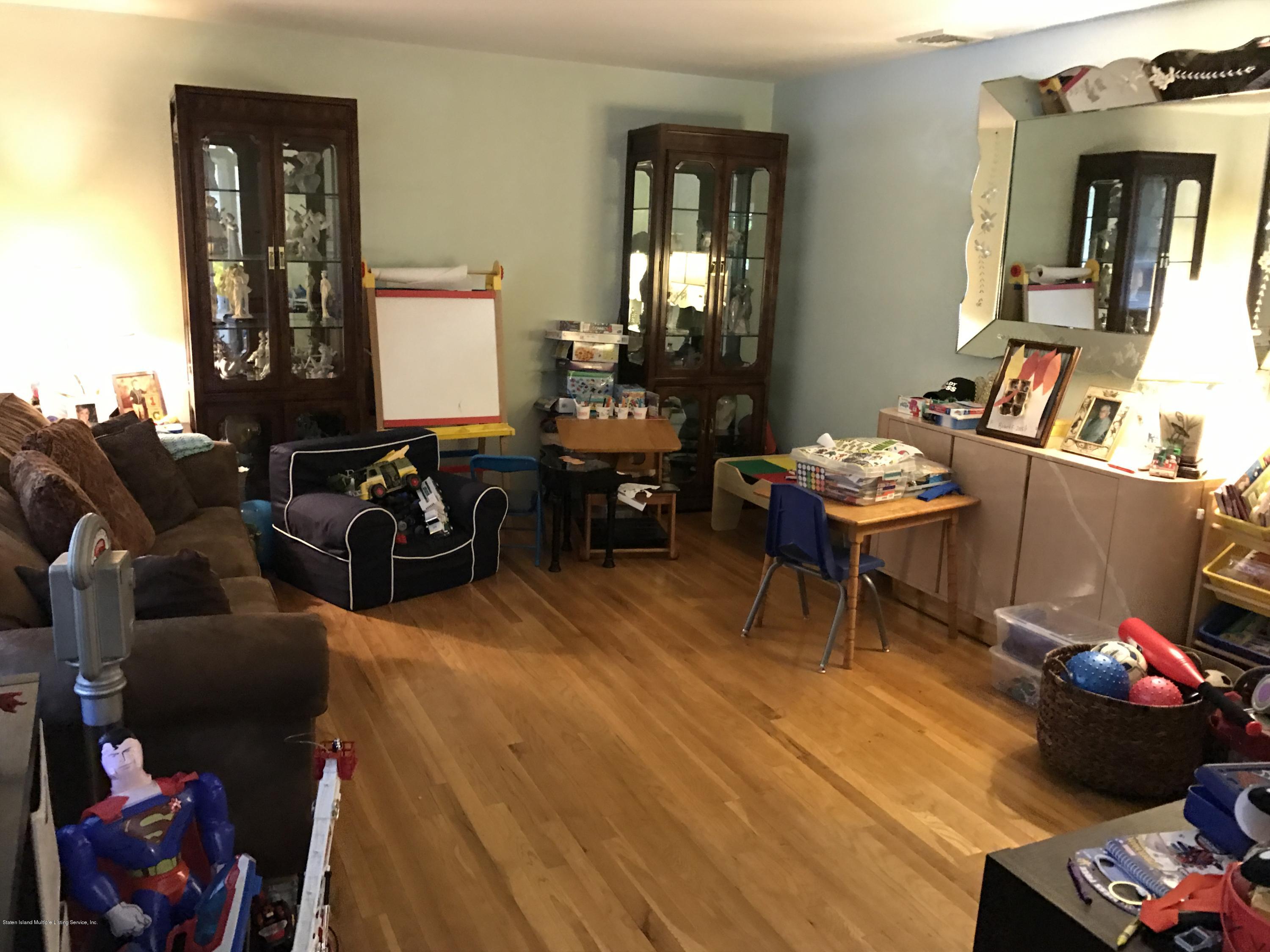 80 Rathbun Avenue Staten Island, NY 10312 - Photo 9 of 21 a living room with furniture and wooden floor