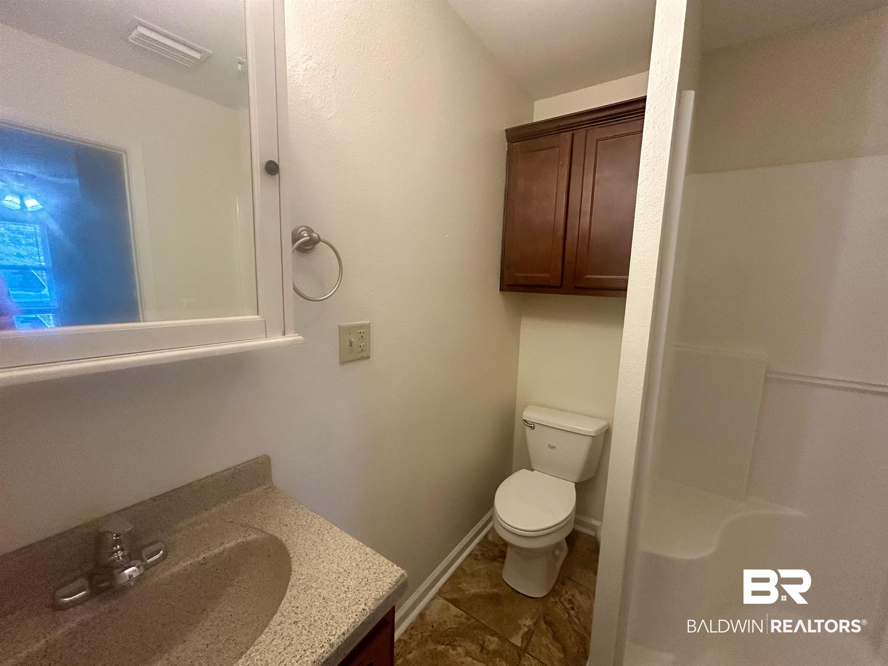 187 Van Hoosen Road Flomaton, AL 36441 - Photo 14 of 29 Full bath featuring vanity, a shower stall, and dark tile patterned flooring