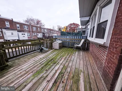 a view of balcony with wooden floor and fence