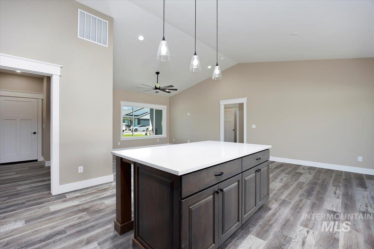 231 Sandi Road Twin Falls, ID 83301 - Photo 11 of 31 Kitchen featuring pendant lighting, a center island, light wood finished floors, ceiling fan, and high vaulted ceiling