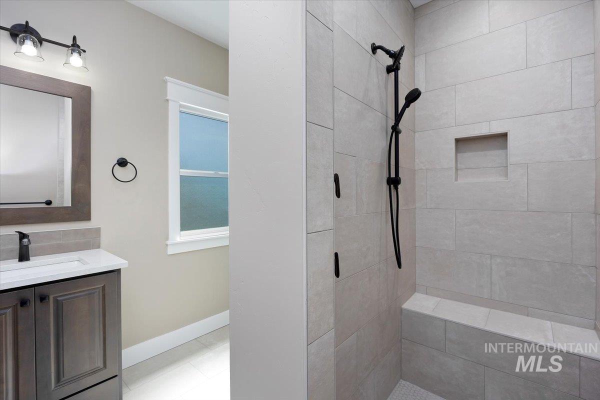 231 Sandi Road Twin Falls, ID 83301 - Photo 18 of 31 Bathroom featuring vanity, a stall shower, and light tile patterned floors