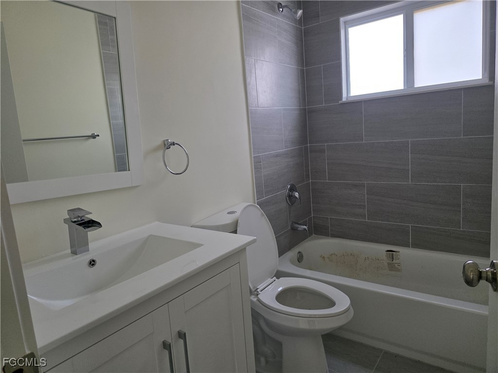 2615 32nd Street Southwest Lehigh Acres, FL 33976 - Photo 15 of 19 a bathroom with a sink and a bathtub