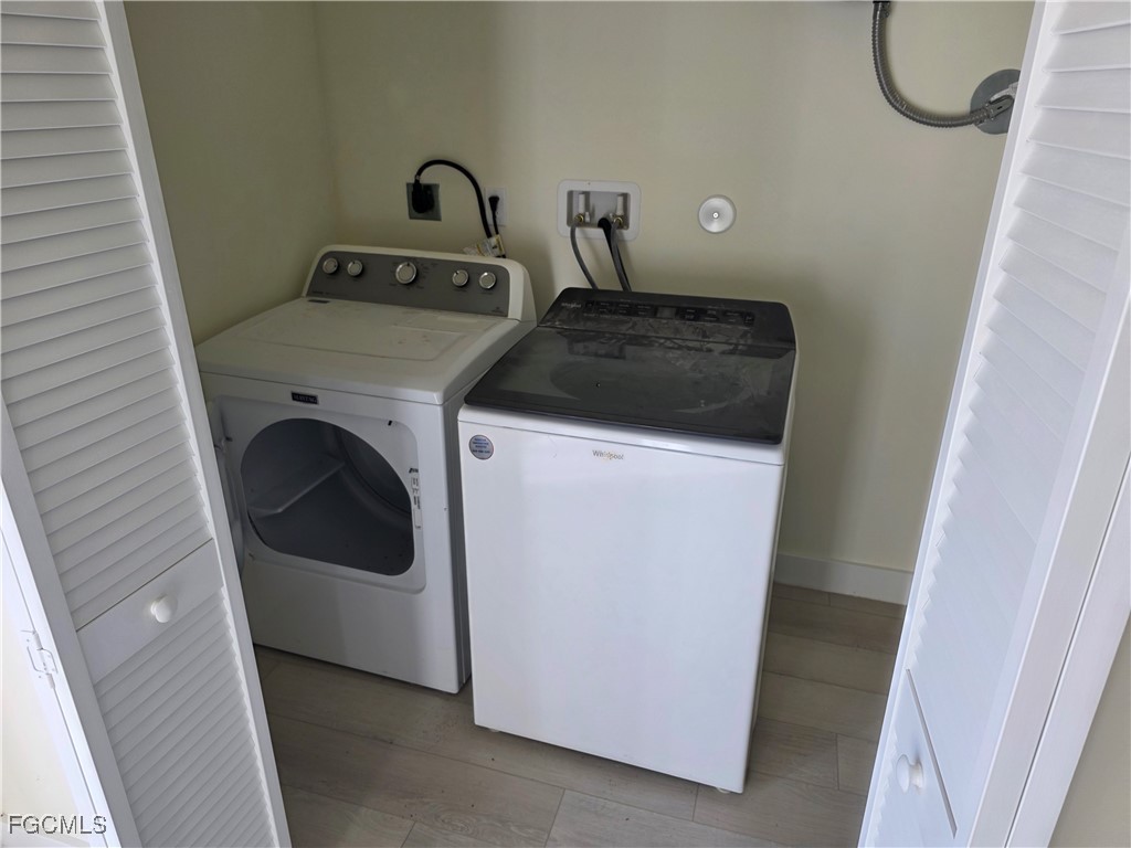 2615 32nd Street Southwest Lehigh Acres, FL 33976 - Photo 18 of 19 a utility room with dryer and washer