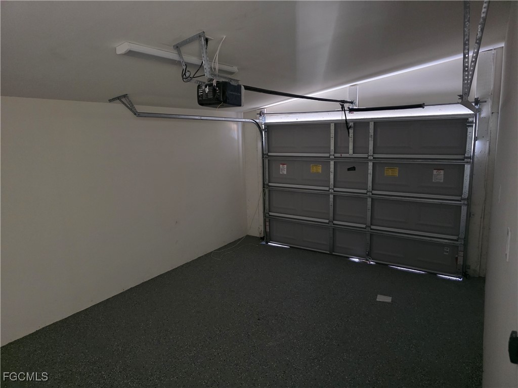 2615 32nd Street Southwest Lehigh Acres, FL 33976 - Photo 19 of 19 a view of storage and utility room with racks on the wall