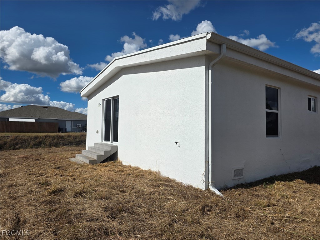 2615 32nd Street Southwest Lehigh Acres, FL 33976 - Photo 4 of 19 a view of a house with a yard