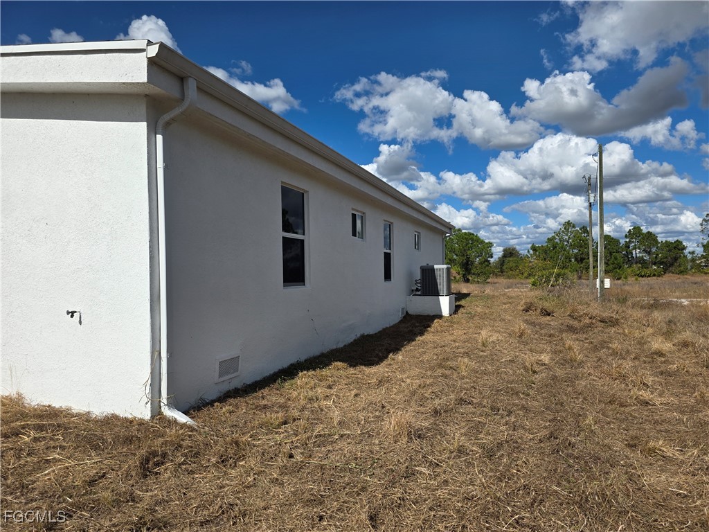 2615 32nd Street Southwest Lehigh Acres, FL 33976 - Photo 6 of 19 a view of a house with a yard