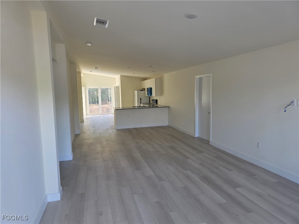 2615 32nd Street Southwest Lehigh Acres, FL 33976 - Photo 8 of 19 a view of a kitchen and wooden floor