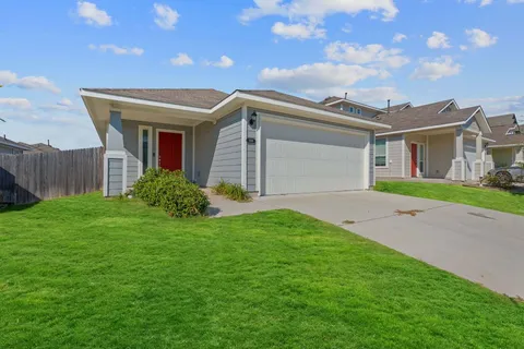 a view of a house with a yard