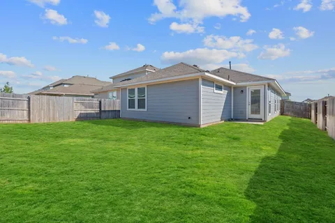 a view of a house with a yard and sitting area