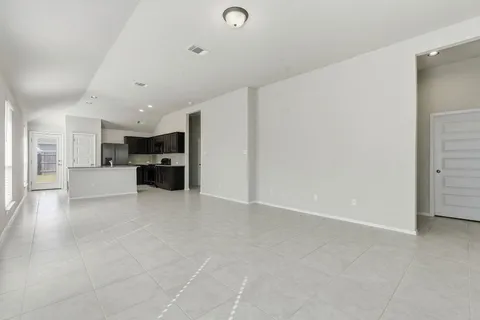 a view of kitchen with furniture and refrigerator
