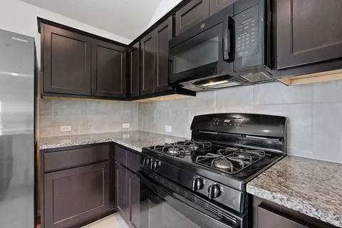 a kitchen with a stove and a microwave