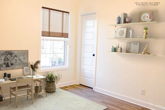 a view of a bedroom with baby crib and a window