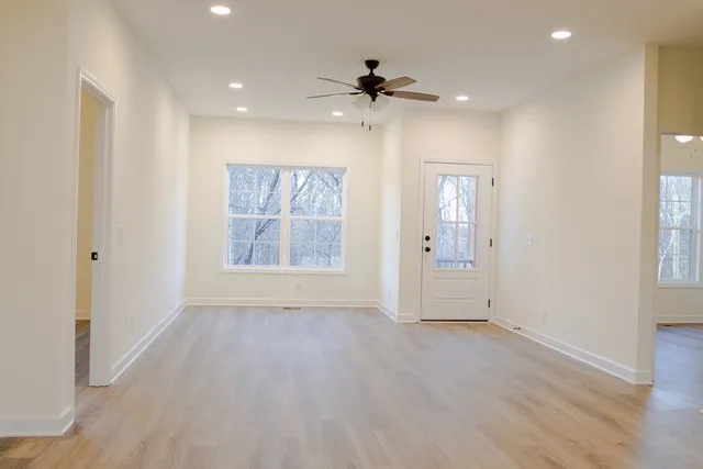 wooden floor in an empty room with a window