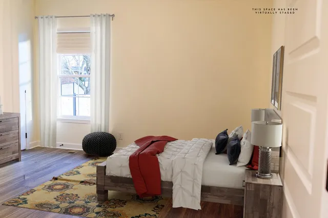 a bedroom with a bed and a window