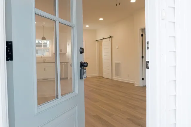 a view of a hallway with wooden floor