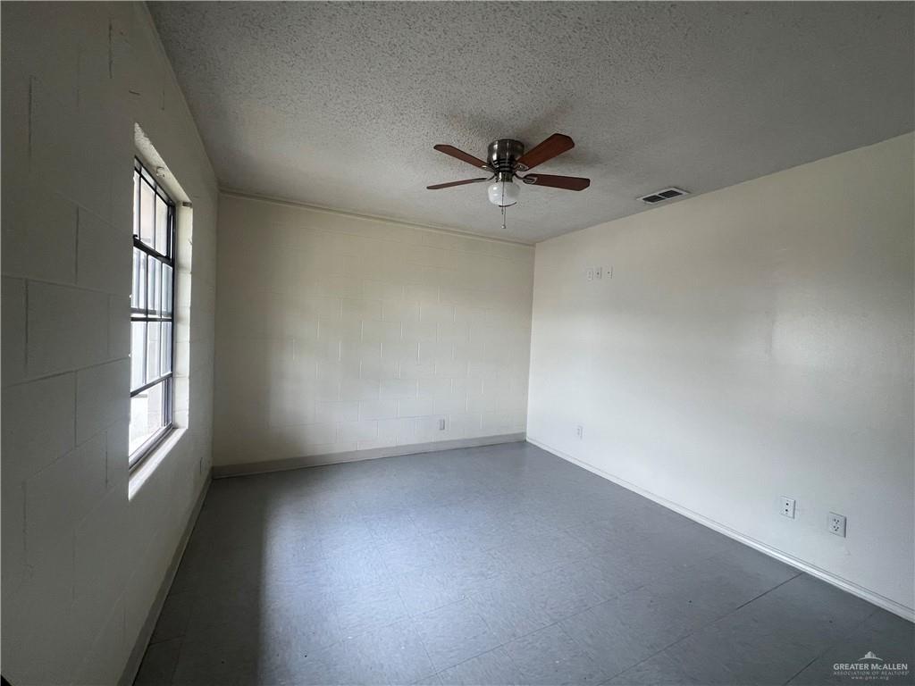 5020 La Homa Road Mission, TX 78574 - Photo 9 of 28 an empty room with windows and ceiling fan