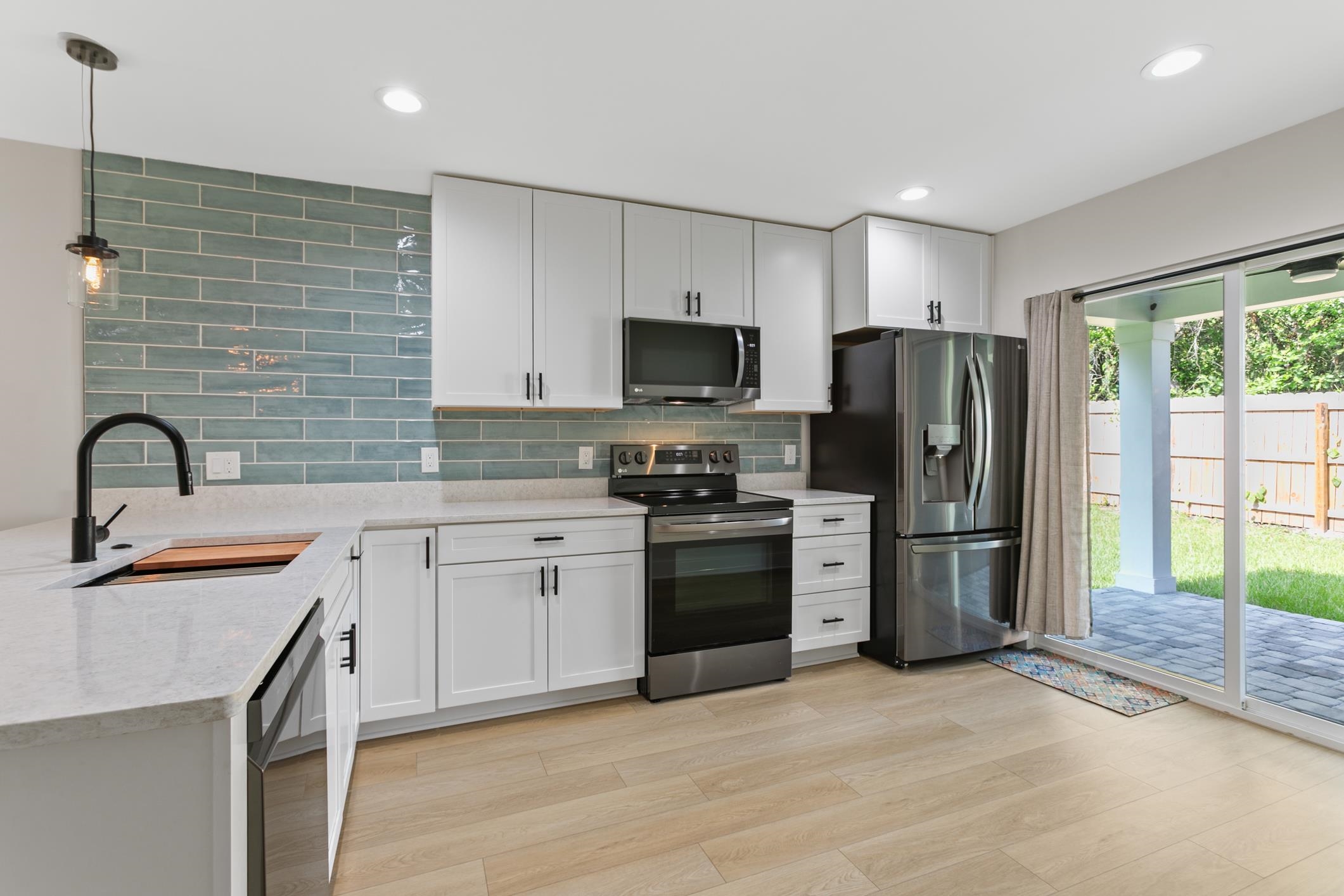 16 Sidney Street St. Augustine, FL 32084 - Photo 11 of 19 a kitchen with stainless steel appliances a refrigerator sink and microwave