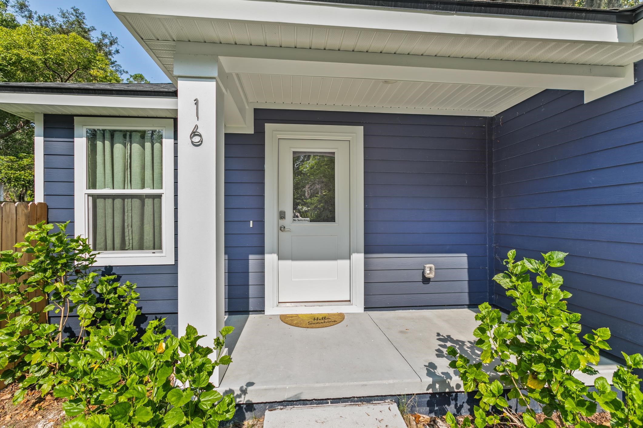 16 Sidney Street St. Augustine, FL 32084 - Photo 5 of 19 a front view of a house with a garden