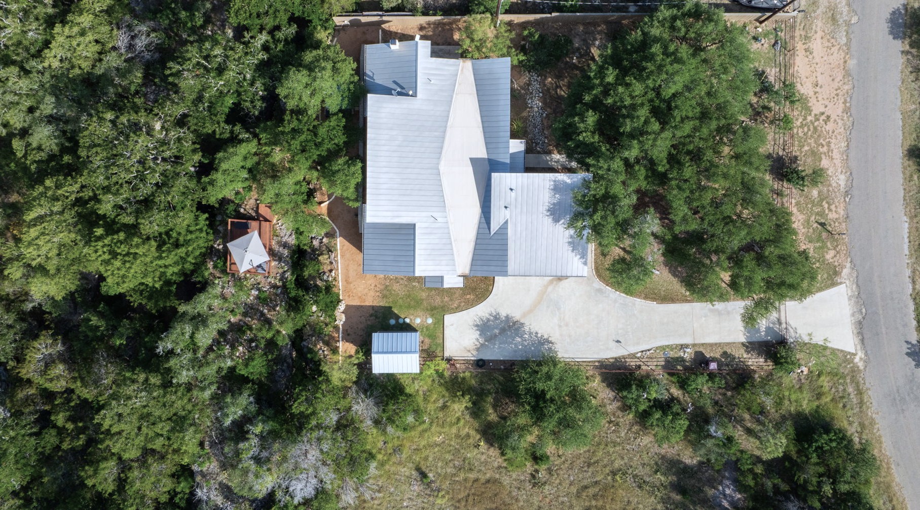 172 Bluff Trail Dripping Springs, TX 78620 - Photo 33 of 40 an aerial view of residential house with outdoor space and trees all around