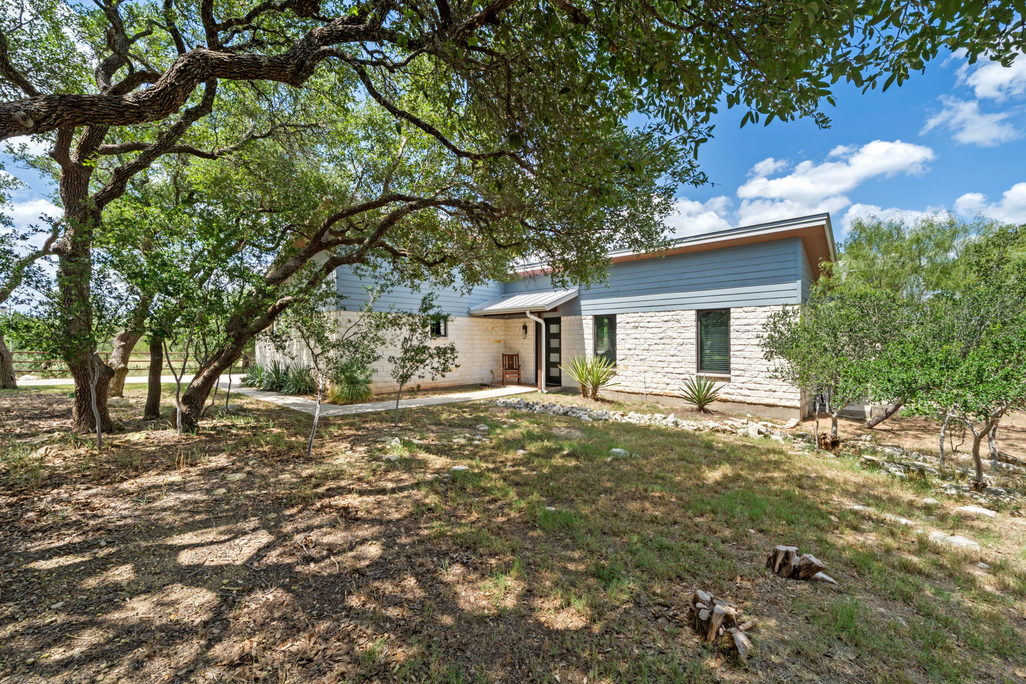 172 Bluff Trail Dripping Springs, TX 78620 - Photo 40 of 40 a view of a yard with a house and a tree