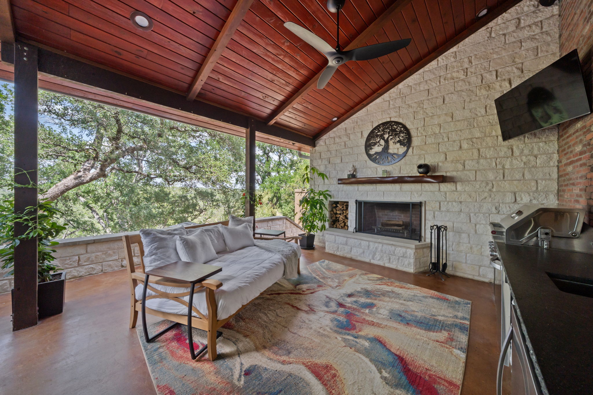 172 Bluff Trail Dripping Springs, TX 78620 - Photo 6 of 40 a living room with furniture a flat screen tv and a fireplace