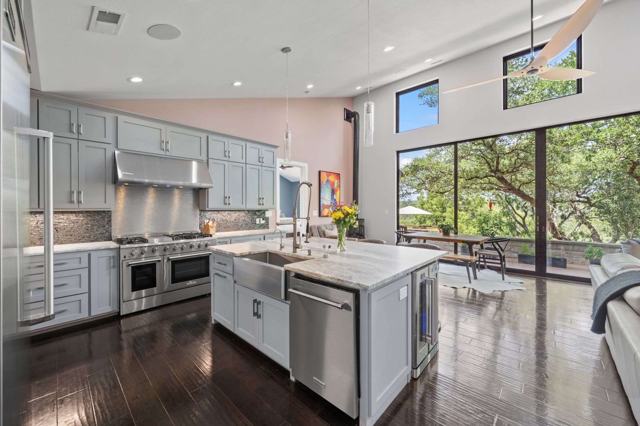 172 Bluff Trail Dripping Springs, TX 78620 - Photo 9 of 40 a kitchen with stainless steel appliances granite countertop a stove and a wooden floors