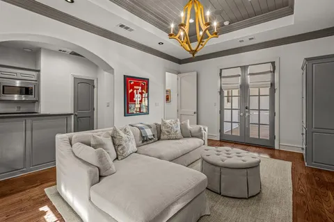 a living room with furniture and a chandelier